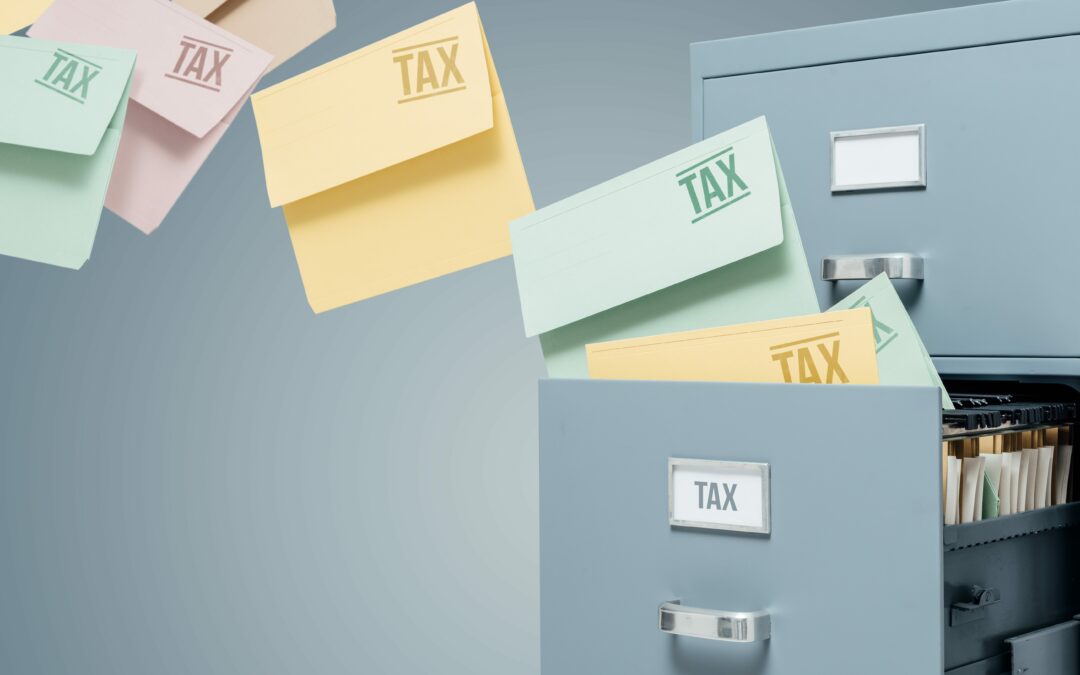 Closeup of filing cabinet with tax documents flying out