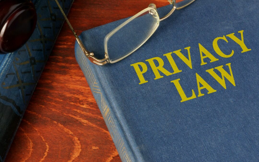 Privacy law book on desk with glasses and gavel