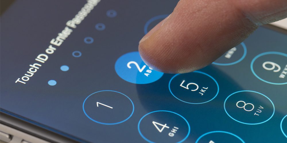 Closeup of thumb typing in mobile phone passcode