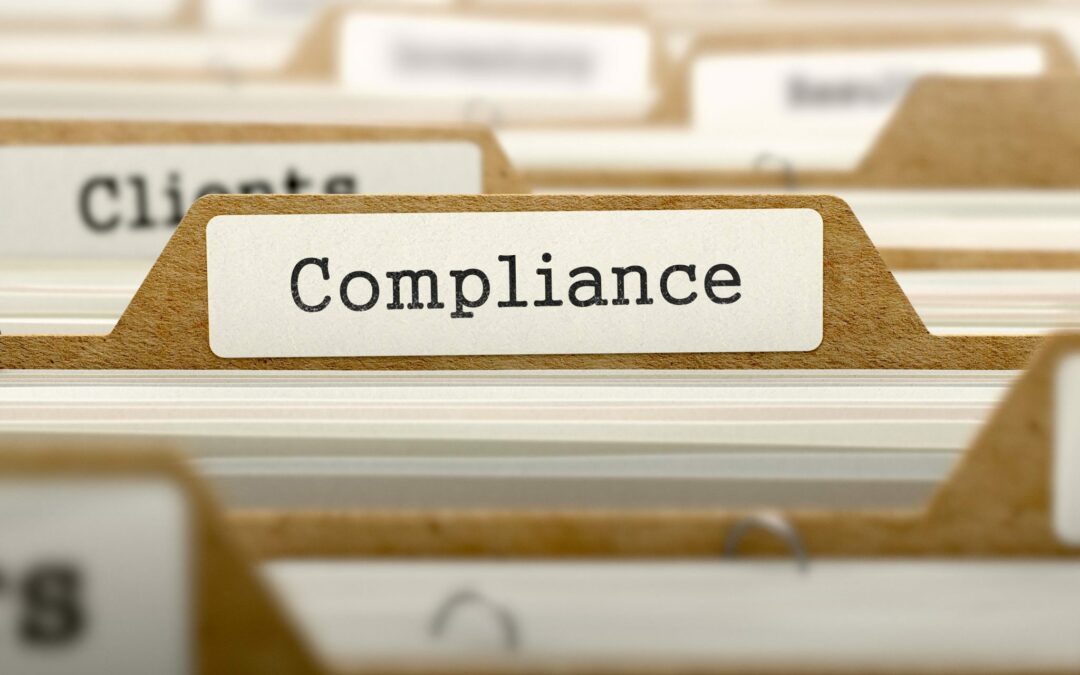 file folder with word "compliance on it"